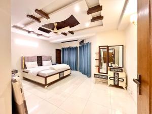 a bedroom with a bed and a mirror at LUXURY 6 Bedroom Holiday Home in Islamabad