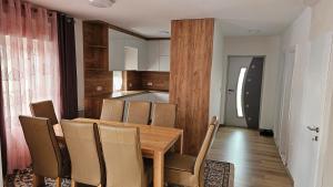 a kitchen and dining room with a wooden table and chairs at Villa Amellina in Ilidža