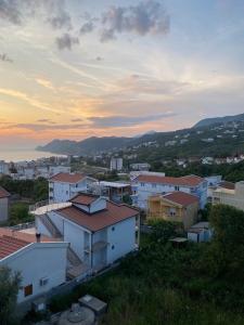 a group of buildings in a city with the sunset at Orlovs Family in Dobra Voda