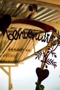a sign with the word enchantment hanging from a roof at LE TERRAZZE SUL GARDA RELAIS in Biaza
