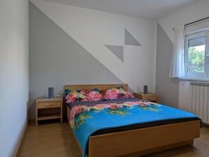 - une chambre avec un lit et une couette bleue dans l'établissement Villa Rosa, à Umag