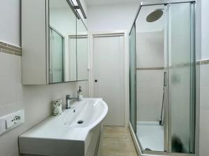 a white bathroom with a sink and a shower at Casa in centro Ischia Porto Forever Four in Ischia +14 photos