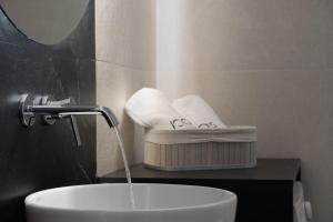 a bathroom sink with water coming out of a faucet at Icos City 1 in Hersonissos +24 photos