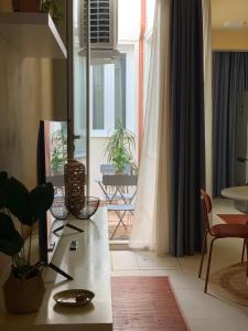a living room with a table and a large window at Apartment Hotel Marchesini in Ravenna