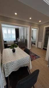 a living room with a table and chairs in a room at KELES HOME in Trabzon