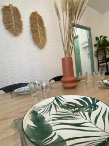 a table with a plate on top of a table at La Suite des Platanes in Perpignan