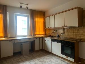 a kitchen with white cabinets and a window at Schwalbacher Residenz in Frankfurt/Main +14 photos