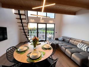 a living room with a table and a couch at Domki Grabina in Grabina