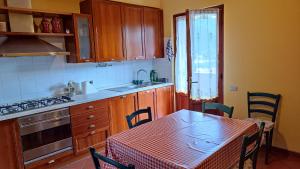 a kitchen with a table and a kitchen with a table and chairs at Casa Daniela in Bagni di Lucca