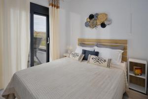 a bedroom with a large white bed with pillows at Hermagio Villa Hermione by Estia in Malia +47 photos
