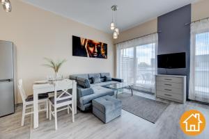 a living room with a couch and a table at Apartamenty Platan - visitopl in Świnoujście