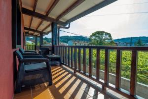 a balcony with chairs and a view at Albergue GBC Caldas in Caldas de Reis