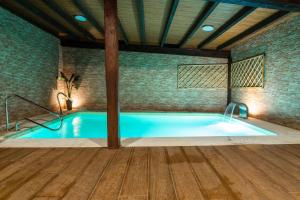 a large pool with a volleyball goal in a room at Albergue GBC Caldas in Caldas de Reis