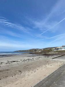 a beach with a blue sky and the ocean at Luxury holiday rental with sea views on the Wild Atlantic Way in Tralee +34 photos