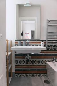a bathroom with a sink and a mirror at Up25 in Naples +38 photos