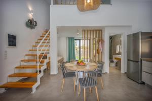 a kitchen and dining room with a table and chairs at Hermagio Villa Mary by Estia in Malia