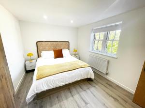 ein Schlafzimmer mit einem großen Bett und einem Fenster in der Unterkunft The Lincoln Apartment 2023 NEW-BUILD in Oxford