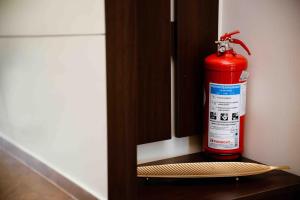 a red fire extinguisher sitting on top of a shelf at The Wave in Tivat