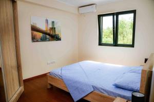 a bedroom with a blue bed and two windows at The Wave in Tivat +49 photos