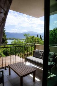 a balcony with a bench and a view of the water at The Wave in Tivat