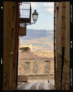an alley with a view of a building with a street light at Salemi BnB in Salemi