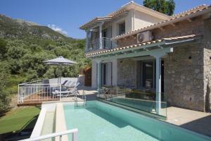 a house with a swimming pool and a patio at Panoutsis Villa Vista in Sívros