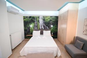 a bedroom with two beds and a waterfall mural on the wall at THE WHOLE PACKET Β3 center with parking in Larisa