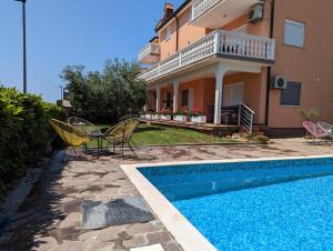 a villa with a swimming pool and a house at Villa Rosa in Umag