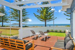 a patio with chairs and a view of the ocean at Saltys 4BRM Beachfront WIFI Pet Friendly in Victor Harbor
