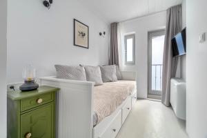 a small bedroom with a bed with a green cabinet at Kastro Residence in Nafplio