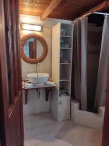 a bathroom with a sink and a mirror at Sunset Apartment in Patmos