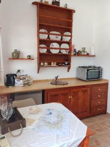 a kitchen with a counter top and a microwave at Sunset Apartment in Patmos