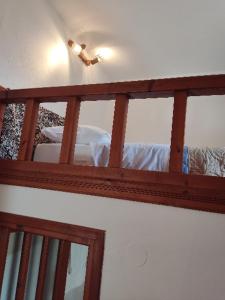a room with a wooden railing with a bed at Sunset Apartment in Patmos