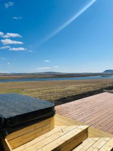 a wooden deck with a view of a body of water at Luxury villa with hot tub & amazing view in Reykholt