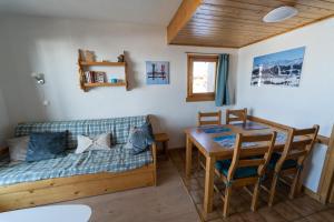 a living room with a couch and a table at Les Saisies appart 1 chambre au pied des pistes in Les Saisies