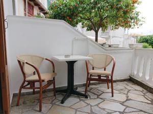 2 stoelen en een witte tafel op een patio bij Postman's house in Parga