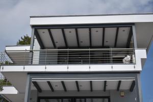 a bird sits on the balcony of a building at Mathesi apartment Sea front in Elia