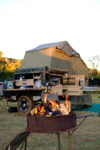 a camp fire in front of a tent at Dream Cruiser in Addo with Private Bath in Kirkwood