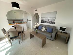 a living room with a couch and a table at Pool paradise in Calpe
