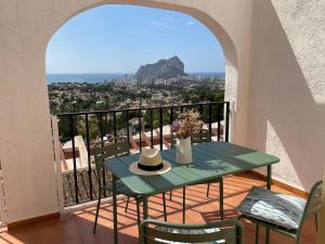 a table with a hat on top of a balcony at Pool paradise in Calpe