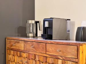 a microwave and a coffee maker on a wooden dresser at Dimora diaz 23a in Siracusa