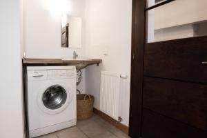 eine Waschküche mit einer Waschmaschine und einem Spiegel in der Unterkunft Apartments 2 in the historic part of Znojmo in Znojmo
