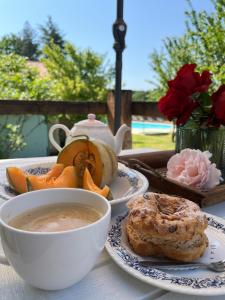 a table with a bowl of soup and a tea pot at La Colline de Tilleul - Les Deux Puits - Cosy Cottage with swimming pool near Aubeterre in Saint-Romain