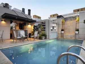 a swimming pool on top of a building at Windsor Hotel in Córdoba