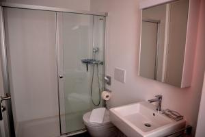 La salle de bains est pourvue d'une douche, de toilettes et d'un lavabo. dans l'établissement Unique Hotel Fusio, à Fusio