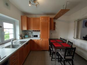 a kitchen with a table with a red table cloth on it at Duplex with garden in Prague