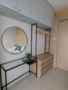 a bathroom with a mirror and a bed in a room at Breezy Tagaytay Condo in Tagaytay +39 photos