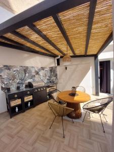 a kitchen with a table and chairs and a stove at Curtigghiu Mondello in Mondello