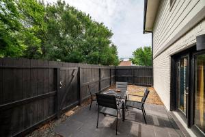 a patio with a table and chairs and a fence at 2 Galleria Downtown 3BR Free Parking Summer Time in Houston