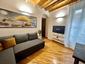a living room with a couch and a tv at Stella / Bergamo center in Bergamo